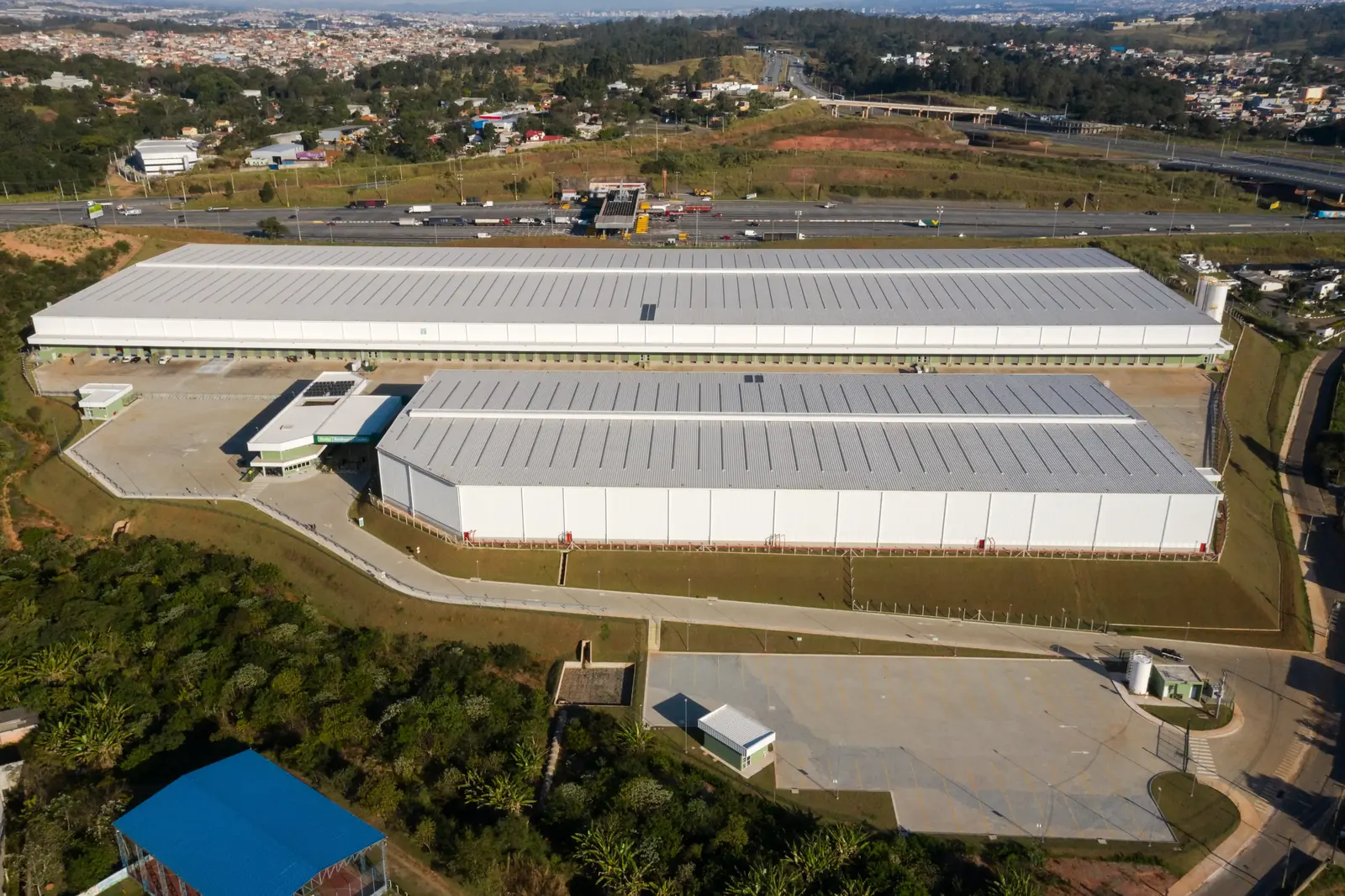 Vista aérea de galpões logísticos ao lado de rodovia em condomínio empresarial na região de Campinas